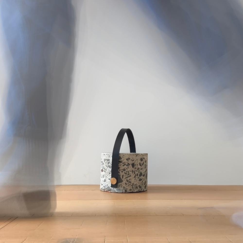 Blurred legs walking past concrete doorstop